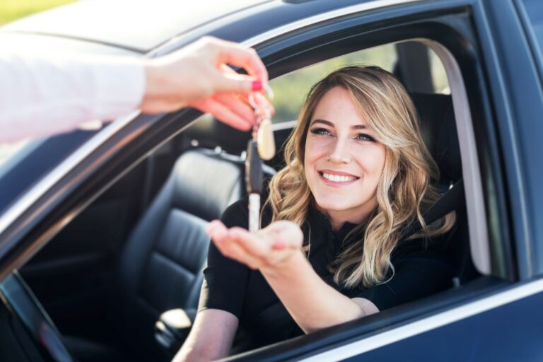 Woman receiving keys to car | Symple Loans