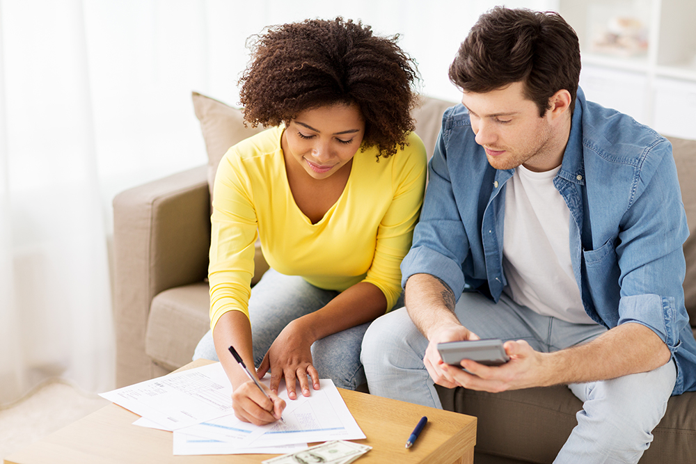 Couple Calculating Debt | Symple Loan
